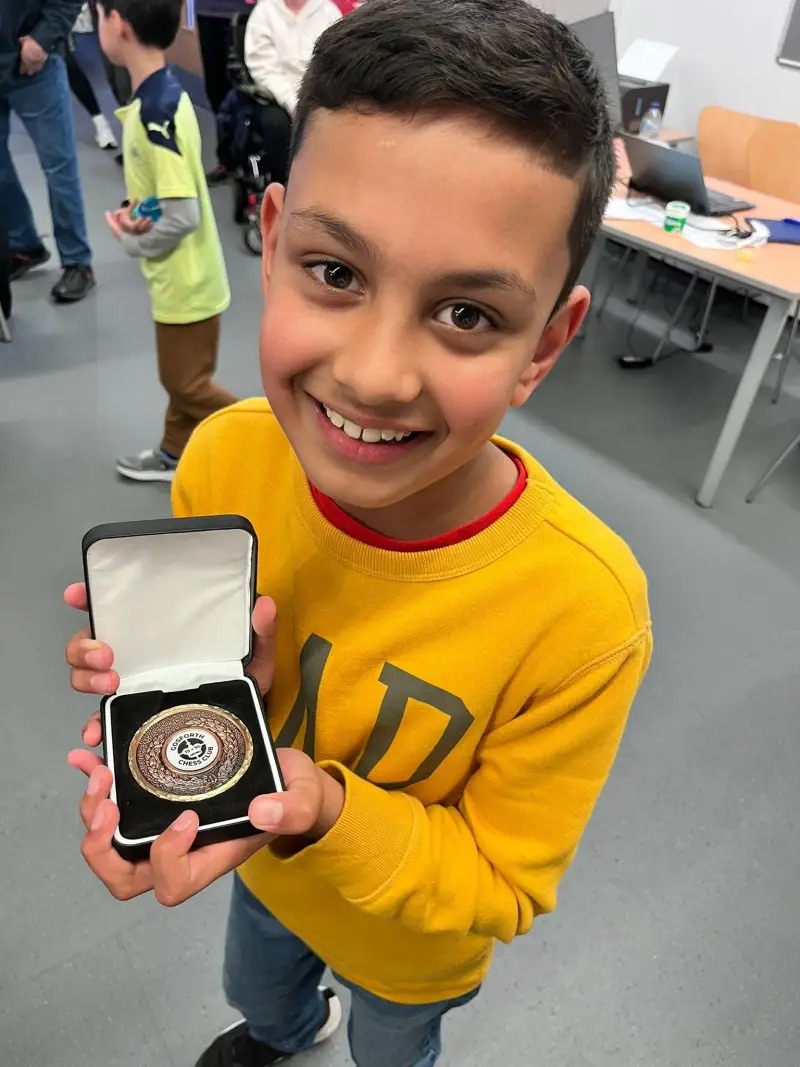 Two students wearing gold medals